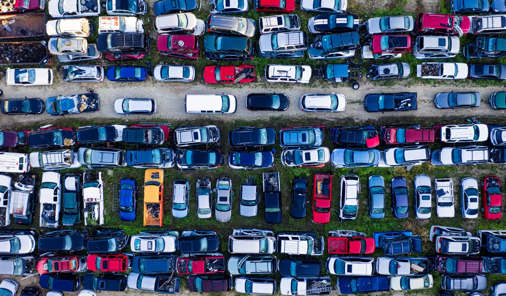 Vista aérea de una campa de desguace con los coches aparcados en filas ordenadas